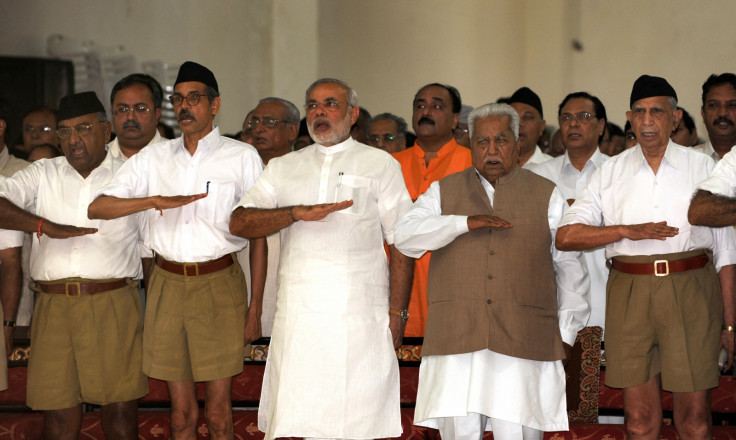 Gujarat state Chief Minister Narendra Modi (3rd L) and former chief minister Keshubhai Patel (2nd R, front) gesture as they attend a Rashtriya Swayamsevak Sangh (RSS) gathering at the Tria Mandir in Adalaj, some 20 kms from Ahmedabad