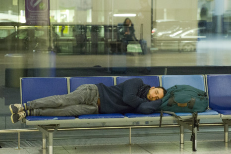 A man gets some rest at Gatwick, after an air traffic control systems failure caused traffic chaos. (Getty)