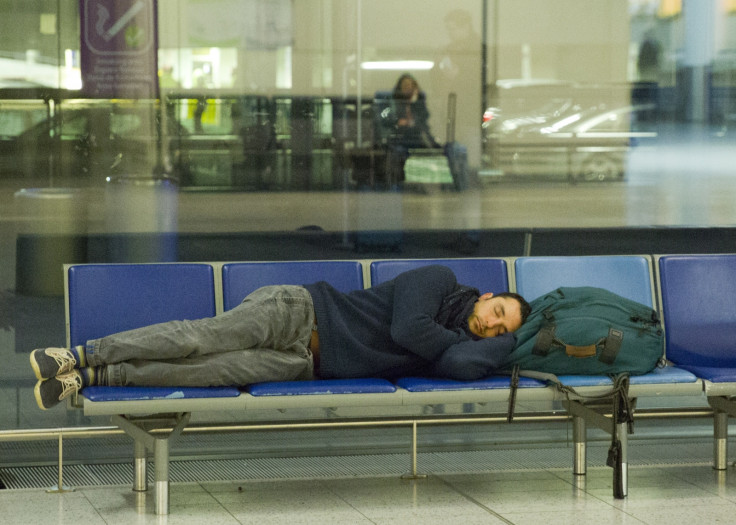 A man gets some rest at Gatwick, after an air traffic control systems failure caused traffic chaos. (Getty)