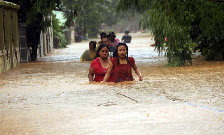 Residents walk through a flooded village in Indonesia
