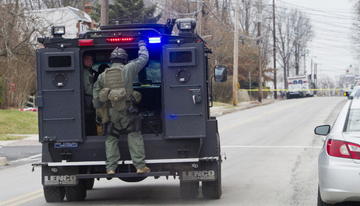 Police SWAT teams search outside a home in a suburb of Philadelphia where a suspect in five killings was believed to be barricaded in Souderton, Pennsylvania