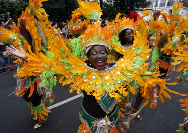 Performers dance at street parade at annual Notting Hill Carnival in central London