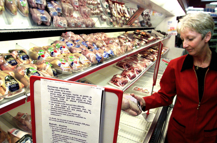 A woman examines a chicken in a Brussels supermarket June 1.