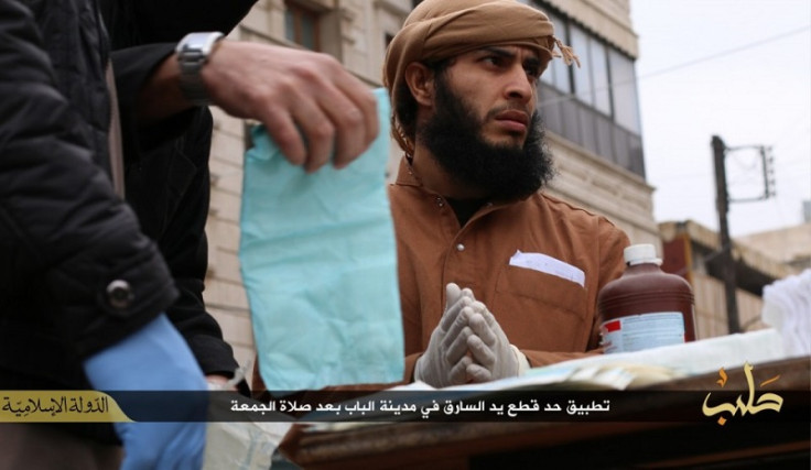 An Isis doctor is shown wearing while surgical gloves before he tends to the amputee