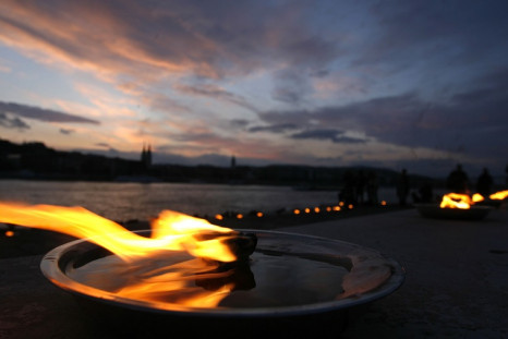 Candles burn at a memorial of shoes in remembrance of Holocaust victims