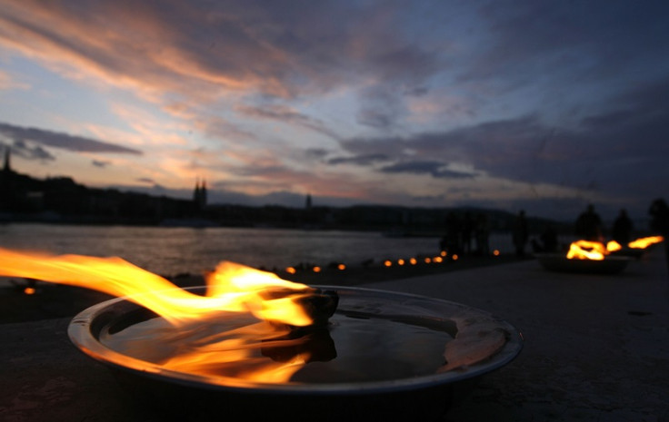 Candles burn at a memorial of shoes in remembrance of Holocaust victims