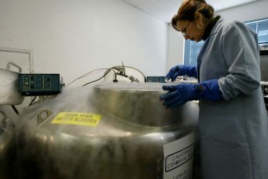 A scientist in California stands over a cryogenic tank. (Reuters)