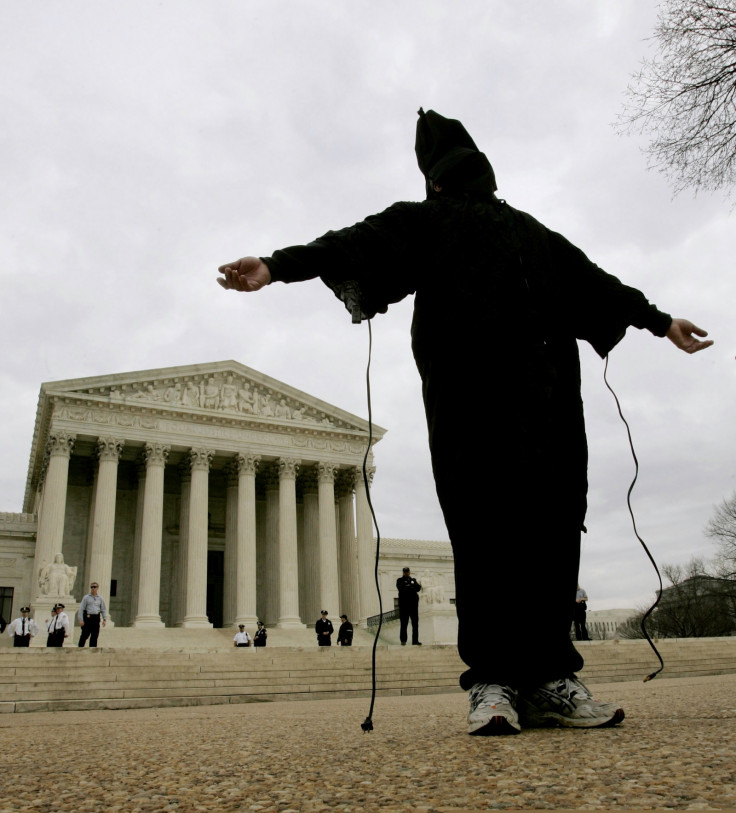 An activist recreates one of the infamous images of detainee abuse in Iraq's Abu Ghraib prison outside the US Supreme Court (Reuters)