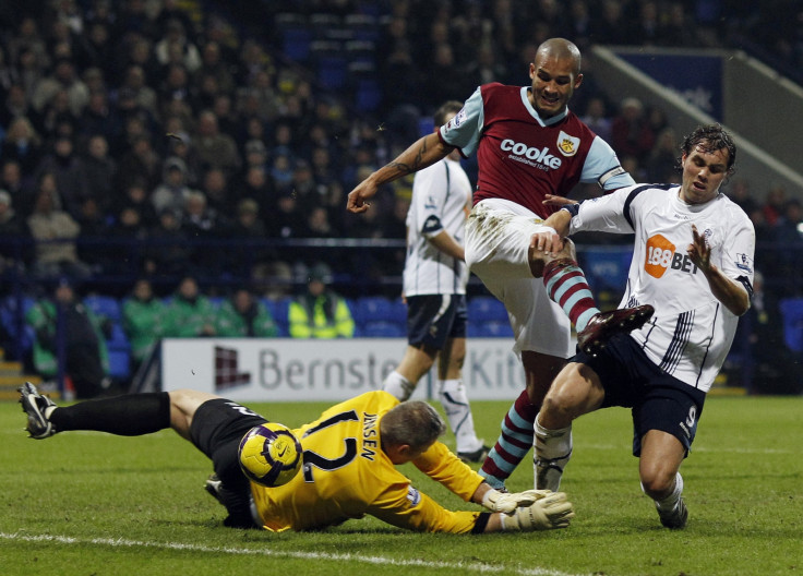 Bolton Wanderers' Johan Elmander is challenged by Burnley's Brian Jensen (L) and Clark Carlisle (C) during their English Premier League soccer match at the Reebok stadium in Bolton