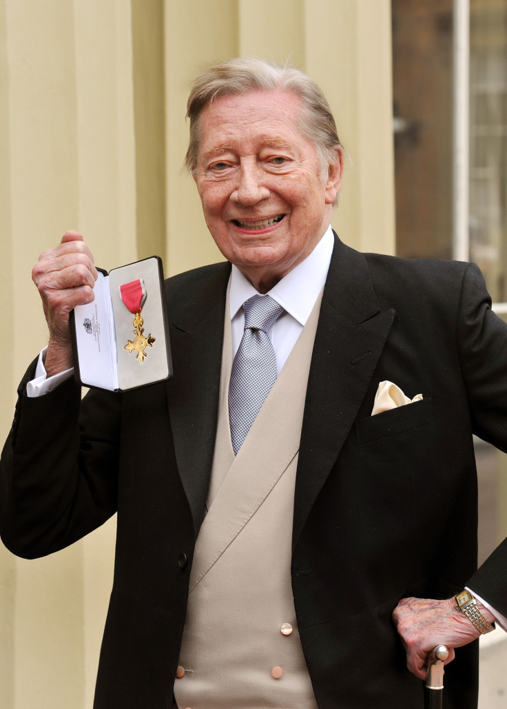 Jeremy Lloyd holds his Officer of the British Empire (OBE) medal after it was presented to him by Queen Elizabeth II at the Investiture Ceremony at Buckingham Palace on February 13, 2012