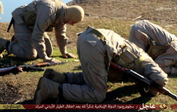 Militants pray after allegedly taking a Jordanian pilot hostage  near Raqqa, Syria.