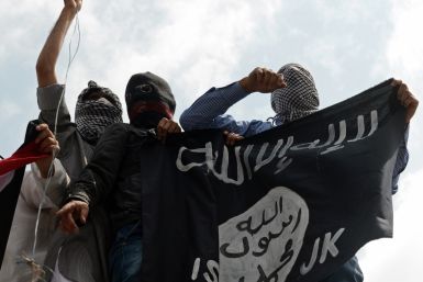 Protesters in Kashmir hold aloft the Isis flag, in recent protests against Israel's bombardment of Gaza. (Getty)
