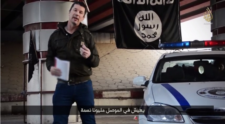 John Cantlie poses next to an Islamic State police car