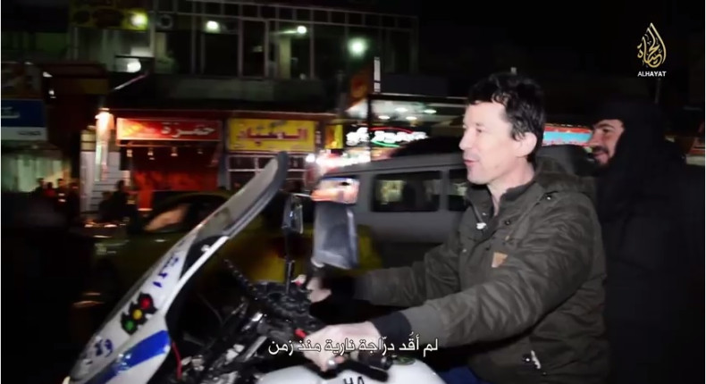 Cantlie on a police motorbike