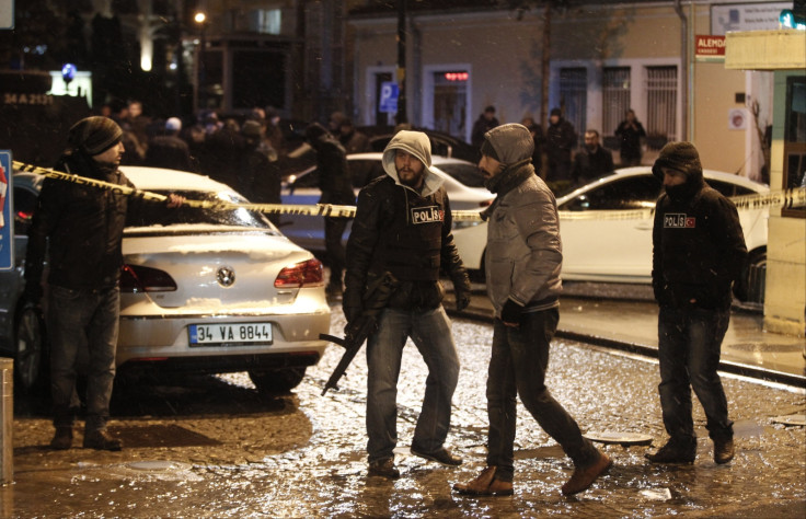 Police officers stand guard at the scene of a bomb blast in Istanbul