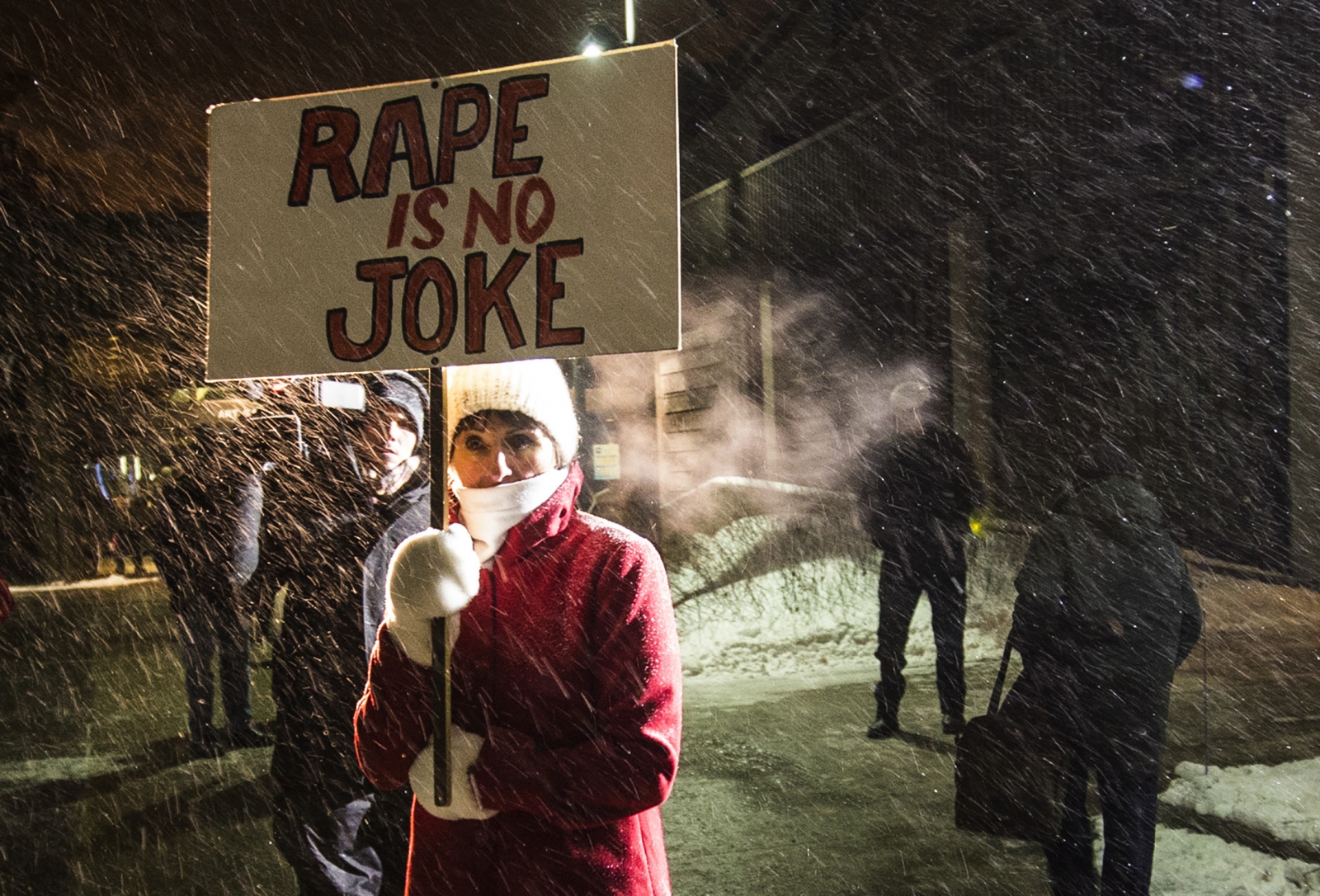 A woman holding a sign that reads A woman holding a sign that reads