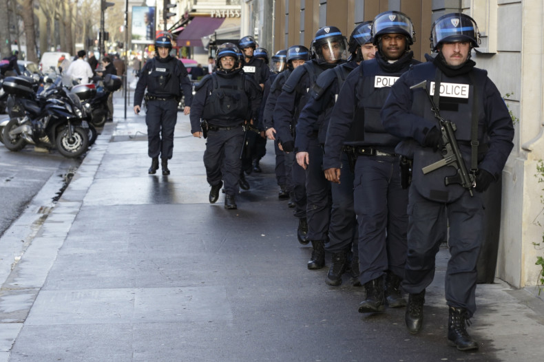 French riot police patrol ahead of the unity rally in central Paris.