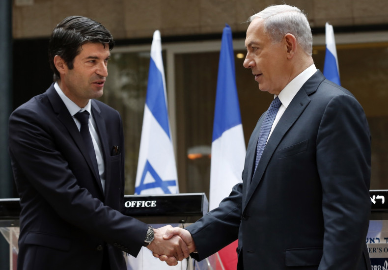 Israeli Prime minister Benjamin Netanyahu (R) shakes hands with French Ambassador to Israel Patrick Maisonnave after presenting his condolences following the deadly attack on French satirical newspaper Charlie Hebdo on January 9, 2015 at the Prime Ministe