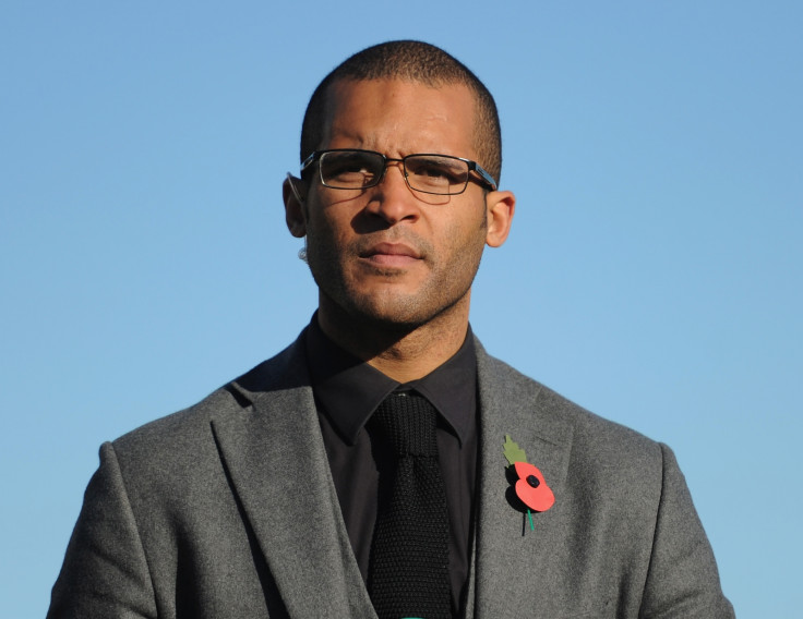 Former footballer Clarke Carlisle has woken up in hospital from his lorry crash injuries