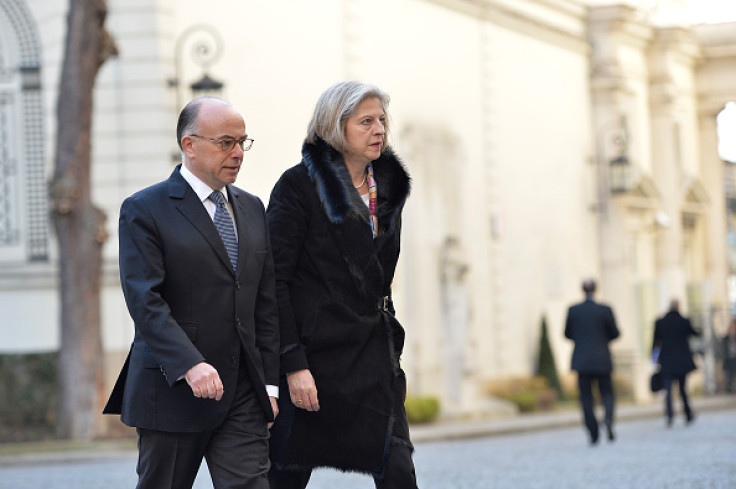 Bernard Cazeneuve (L), French Minister of Interior welcomes Theresa May