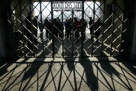 People at a gate in Buchenwald concentration camp, reading: 'To each his own'