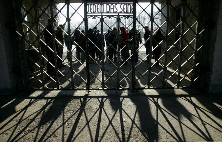 People at a gate in Buchenwald concentration camp, reading: 'To each his own'