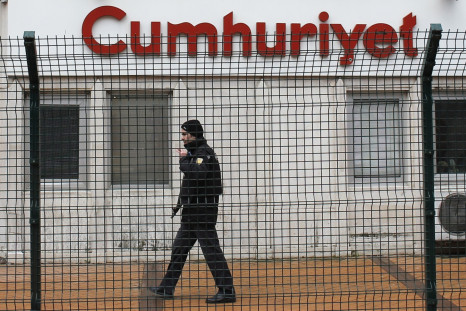 A private security employee stands guard at the entrance of daily newspaper Cumhuriyet's offices