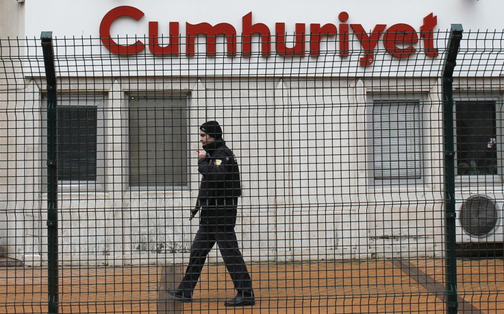 A private security employee stands guard at the entrance of daily newspaper Cumhuriyet's offices