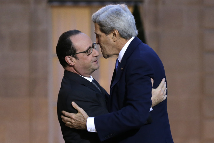 French President Francois Hollande (L) welcomes U.S. Secretary of State John Kerry