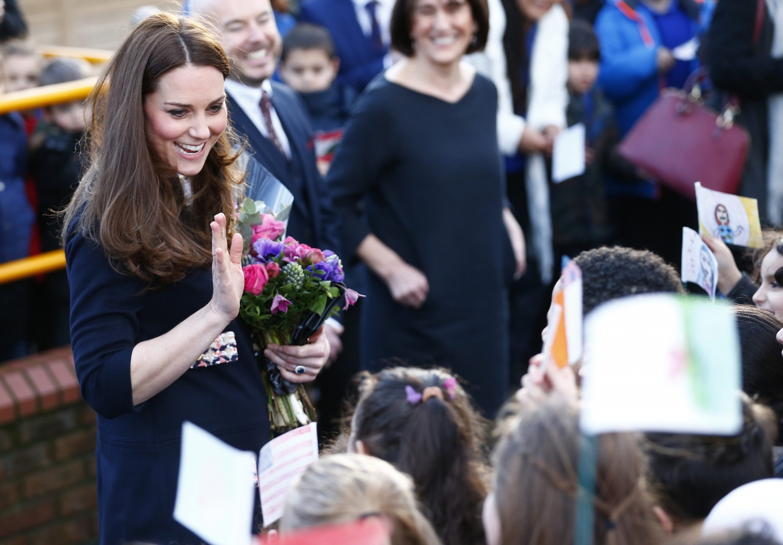 Duchess of Cambridge shows off beginnings of baby bump during school ...