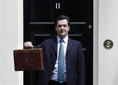 Chancellor George Osborne holds Gladstone's old Budget box for the cameras outside 11 Downing Street