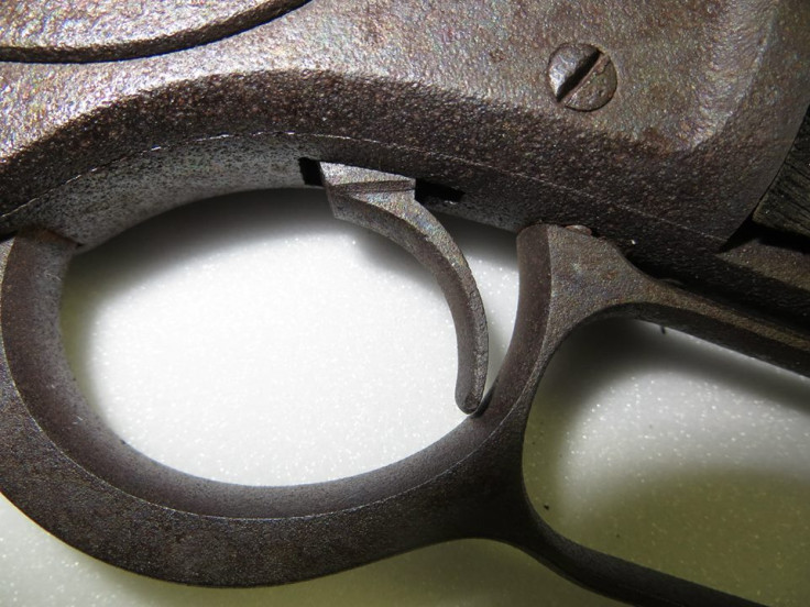 The rusted trigger of the Winchester Model 1873