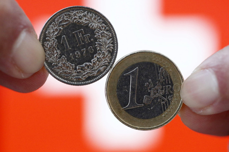 A one Swiss franc coin (L) and a one Euro coin