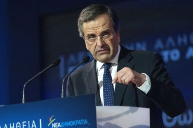 Greek Prime Minister and leader of the conservative New Democracy party Antonis Samaras addresses supporters during an election rally