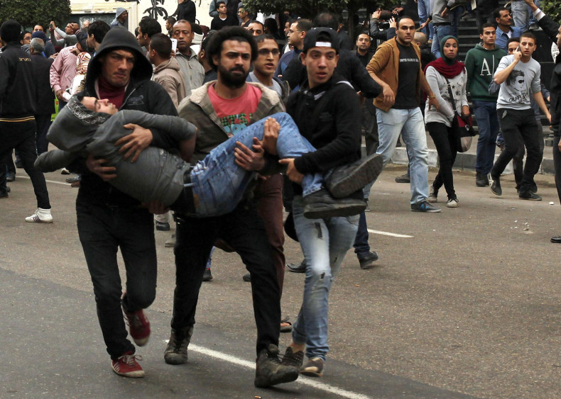 Anti-goverment protesters help an injured demonstrator in Cairo. (Reuters)