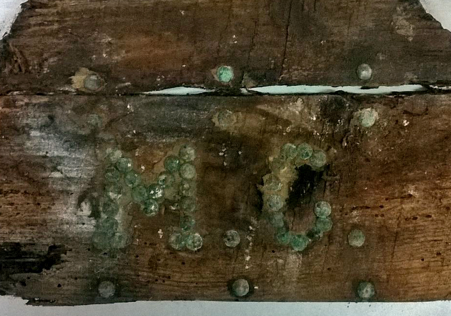 The remains of a wooden casket marked with the initials MC. The coffin could have housed the remains of Miguel de Cervantes