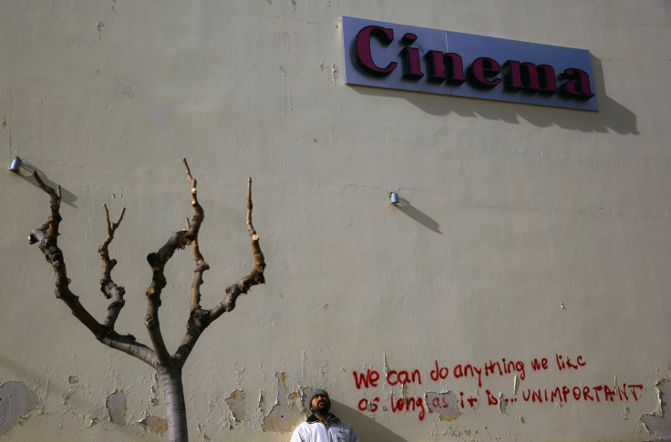 Michael, 36-year-old and unemployed, poses by an abandoned open-air cinema in central Athens February 8, 2013. Michael worked as a hotel clerk for over fifteen years but when the hotel closed he was unable to find work and in late 2011 became homeless.