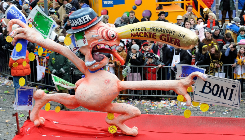 A Rosenmontag float depicts a grasping banker (Getty)