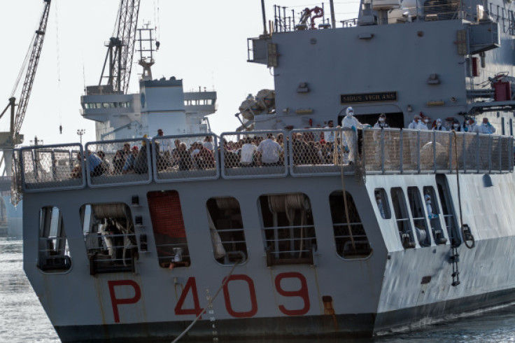 Rescued Syrian refugees arrive in Palermo, Italy, on board an Italian coast guard boat. (Getty)