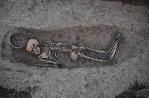 A young woman (16 years old) lying on her stomach in the grave, buried with pottery