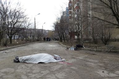 The bodies of victims are seen outside a building neighbouring a hospital in Donetsk