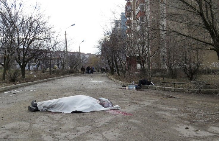 The bodies of victims are seen outside a building neighbouring a hospital in Donetsk