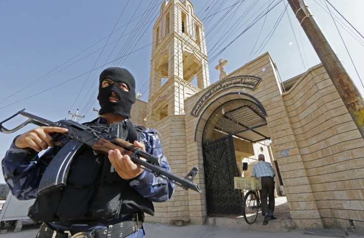 An Iraqi security officer, stands guard outside the Church of the Virgin Mary in the northern town of Bartala east of the northern city of Mosul (Getty)