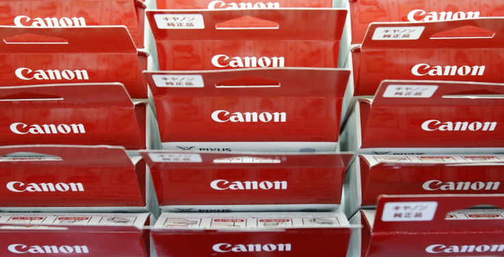 Canon's logos are pictured on printer ink packages displayed at an electronics retail store in Tokyo
