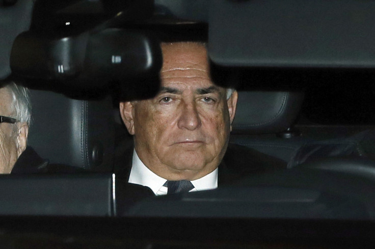 Former IMF head Dominique Strauss-Kahn rides in the backseat of a car as he leaves after the first day of trial in the so-called Carlton Affair, in Lille