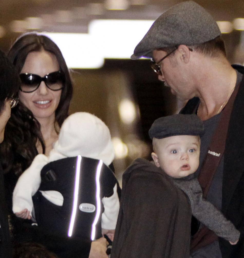 U.S. actors Pitt and Jolie arrive with their children at Narita airport.
