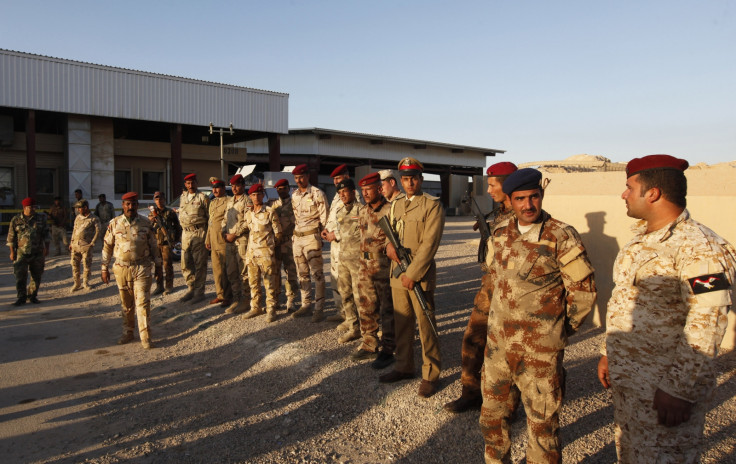 Iraqi security forces keep watch during a tribal conference, regarding the Islamic State, at the Ain al-Assad military base in the Anbar province