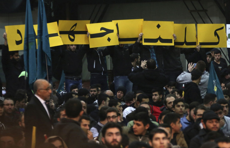 Supporters of Lebanon's Hezbollah leader Sayyed Hassan Nasrallah hold up placards during a rally