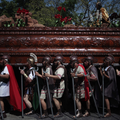 Men, dressed in traditional Roman costumes, carry a statue of Jesus Nazareno during a procession to mark the second Sunday of Lent, in the streets of Guatemala City