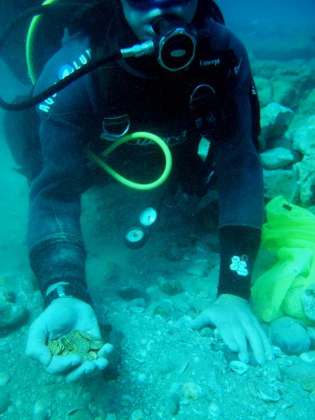 Scuba divers picked out what they thought was a toy coin, only for it to be confirmed as a genuine ancient gold coin. Scuba divers picked out what they thought was a toy coin, only for it to be confirmed as a genuine ancient gold coin.